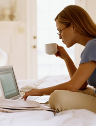 Woman Drinking Coffee Looking at Computer_full.png